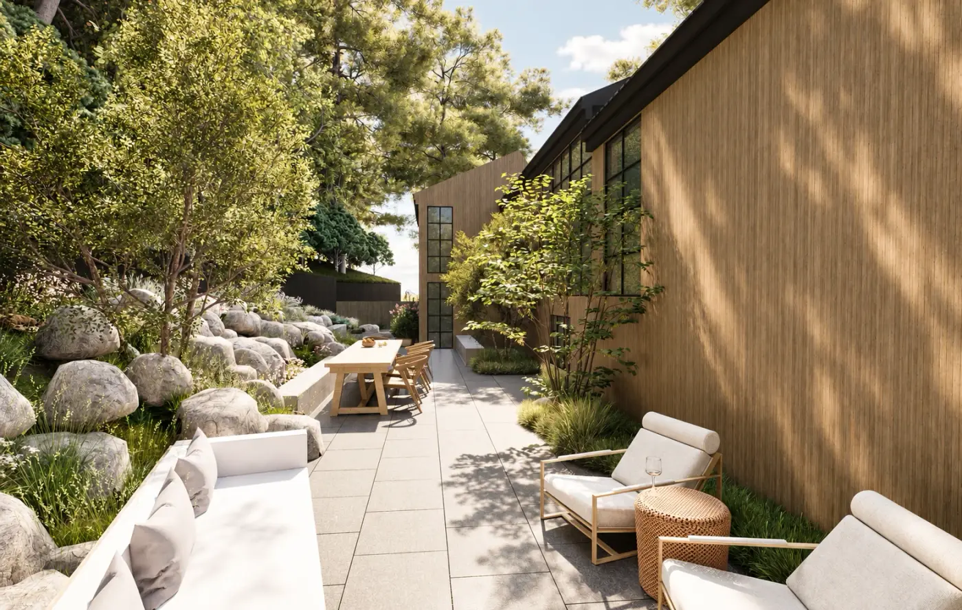 Rendering of a stone-edged terrace with lounge chairs beside a timber-clad building and boulders