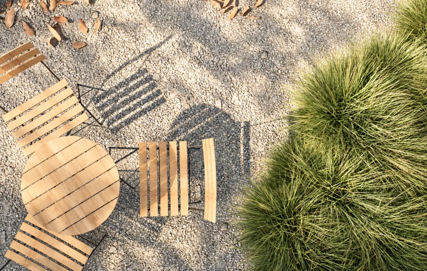 Rendering of timber chairs and a table on gravel among grasses seen from above